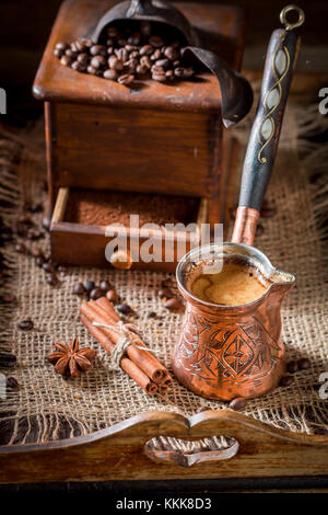 Freshly milled coffee with pot boiled coffee and beans Stock Photo