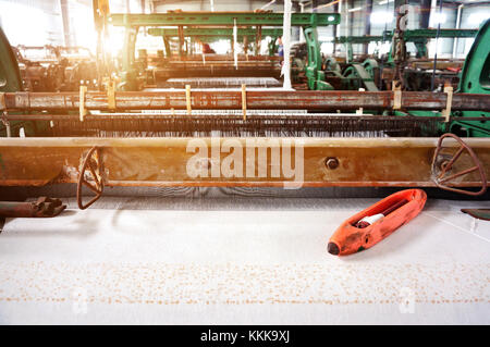 Old-fashioned loom, arranged in the factory workshop. Stock Photo