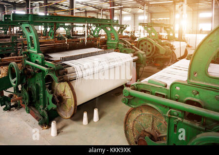 Old-fashioned loom, arranged in the factory workshop. Stock Photo