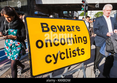 England, London, Beware Oncoming Cyclists Warning Sign Stock Photo - Alamy