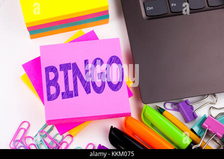 Writing text showing Bingo made in the office with surroundings such as laptop, marker, pen. Business concept for Lettering Gambling to Win Price Succ Stock Photo