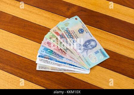 Vietnam Dong banknotes on wooden table Stock Photo