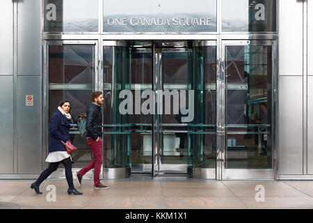 London, UK - November 24, 2017 - Entrance of One Canada Square, a skyscraper in Canary Wharf, with people walking in motion in front of the doors Stock Photo