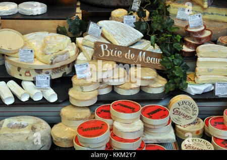 A selection of french Brie and other cheeses on a continental and french cheese stall at borough market in London. Delicatessen foods and cheeses. Stock Photo