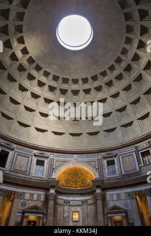 Inside the Pantheon in Rome, Italy looking up at the oculus (hole) in the ceiling and it's geometric dome design. Stock Photo