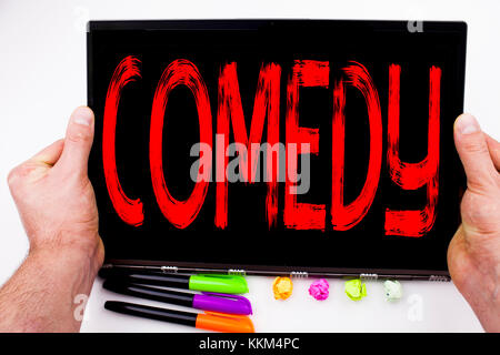 Comedy text written on tablet, computer in the office with marker, pen, stationery. Business concept for Stand Up Comedy Microphone white background w Stock Photo