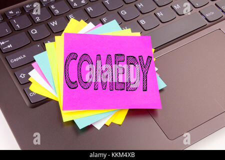 Writing Comedy text made in the office close-up on laptop computer keyboard. Business concept for Stand Up Comedy Microphone Workshop on the black bac Stock Photo