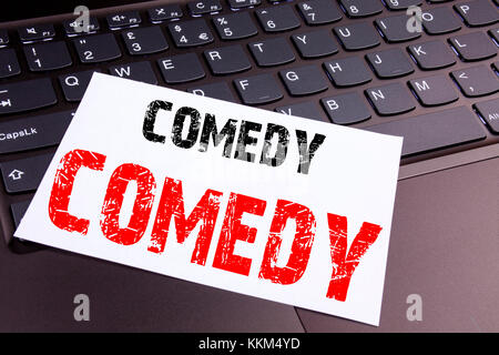 Writing Comedy text made in the office close-up on laptop computer keyboard. Business concept for Stand Up Comedy Microphone Workshop on the black bac Stock Photo