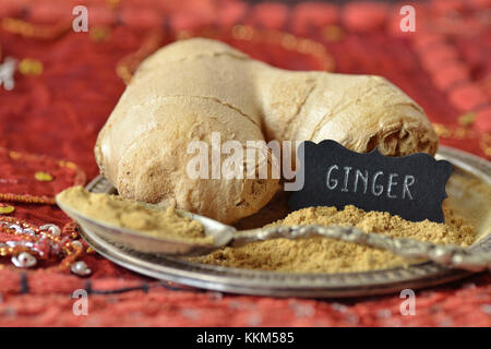 Ginger root and ginger powder over indian carpet Stock Photo