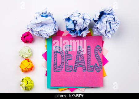 Writing text showing Deals written on sticky note in office with screw paper balls. Business concept for Advertising Deal on white isolated background Stock Photo