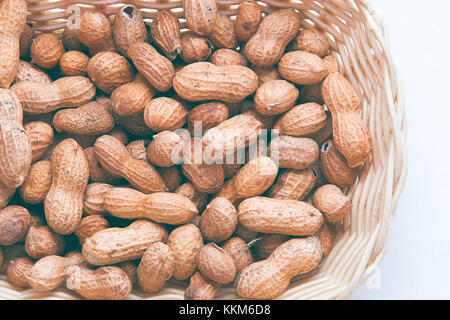 Peanut in the basket on white background made up of salted peanuts in their shells Stock Photo