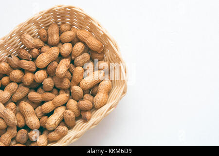 Peanut in the basket on white background made up of salted peanuts in their shells Stock Photo