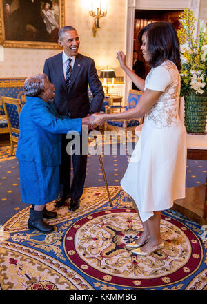 President Barack Obama watches First Lady Michelle Obama dance with 106-Year-Old Virginia McLaurin in the Blue Room of the White House prior to a reception celebrating African American History Month, Feb. 18, 2016.   (Official White House Photo by Pete Souza)  This official White House photograph is being made available only for publication by news organizations and/or for personal use printing by the subject(s) of the photograph. The photograph may not be manipulated in any way and may not be used in commercial or political materials, advertisements, emails, products, promotions that in any w Stock Photo