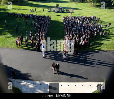 Sept. 11, 2015 'The President and First Lady walk back towards the south entrance of the White House following a moment of silence with White House staff for the victims of the 9/11 terrorist attacks. I hid behind a planter on the Truman Balcony to make this photograph.' (Official White House Photo by Pete Souza) This official White House photograph is being made available only for publication by news organizations and/or for personal use printing by the subject(s) of the photograph. The photograph may not be manipulated in any way and may not be used in commercial or political materials, adve Stock Photo