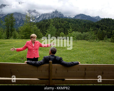 June 8, 2015 'We were at the G7 Summit in Krün, Germany. Chancellor Angela Merkel asked the leaders and outreach guests to make their way to a bench for a group photograph. The President happened to sit down first, followed closely by the Chancellor. I only had time to make a couple of frames before the background was cluttered with other people.' (Official White House Photo by Pete Souza) This official White House photograph is being made available only for publication by news organizations and/or for personal use printing by the subject(s) of the photograph. The photograph may not be manipul Stock Photo