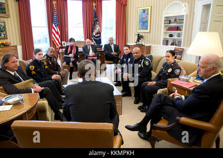 President Barack Obama and Vice President Joe Biden meet with rank-and-file law enforcement officials from across the country, in the Oval Office, Feb. 24, 2015. They discuss how communities and law enforcement can work together to build trust to ensure public safety and strengthen neighborhoods. (Official White House Photo by Pete Souza)  This official White House photograph is being made available only for publication by news organizations and/or for personal use printing by the subject(s) of the photograph. The photograph may not be manipulated in any way and may not be used in commercial o Stock Photo