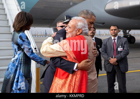 President Barack Obama, with First Lady Michelle Obama, greets Prime Minister Narendra Modi upon arrival at Air Force Station Palam in New Delhi, India, Jan. 25, 2015. (Official White House Photo by Pete Souza)  This official White House photograph is being made available only for publication by news organizations and/or for personal use printing by the subject(s) of the photograph. The photograph may not be manipulated in any way and may not be used in commercial or political materials, advertisements, emails, products, promotions that in any way suggests approval or endorsement of the Presid Stock Photo