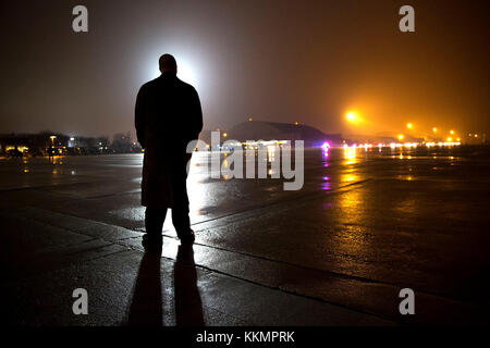 A Secret Service agent stands on the tarmac waiting for President Barack Obama and First Lady Michelle Obama to arrive by motorcade at Joint Base Andrews, Md. prior to departure en route to New Delhi, India, Jan. 24, 2015. (Official White House Photo by Pete Souza)  This official White House photograph is being made available only for publication by news organizations and/or for personal use printing by the subject(s) of the photograph. The photograph may not be manipulated in any way and may not be used in commercial or political materials, advertisements, emails, products, promotions that in Stock Photo