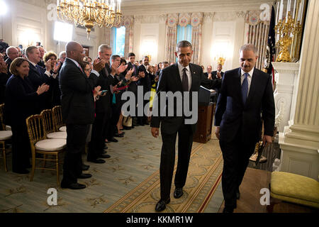 President Barack Obama and Attorney General Eric H. Holder, Jr., depart the State Dining Room of the White House after statements announcing Holder's resignation Sept. 25, 2014. Stock Photo