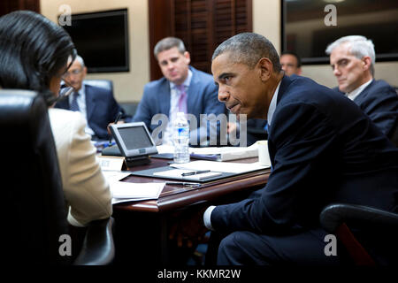President Barack Obama listens to National Security Advisor Susan E. Rice during a National Security Council  meeting to prep for the United Nations General Assembly, in the Situation Room of the White House, Sept. 19, 2014. John Podesta, Counselor to the President, Senior Advisor Dan Pfeiffer and Chief of Staff Denis McDonough, right, also listen. Stock Photo