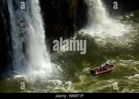 Tourist boat under Iguazu Falls, Brazil - Argentina Border, South America Stock Photo