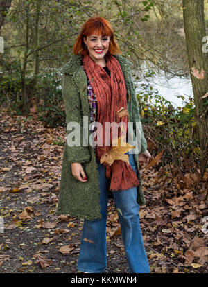 girl walking on forest path in autumn with leaves Stock Photo