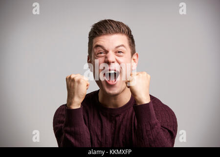 Portrait of a celebrating young man white looking up Stock Photo
