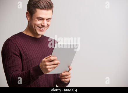 Smiling young white man holding a tablet computer Stock Photo