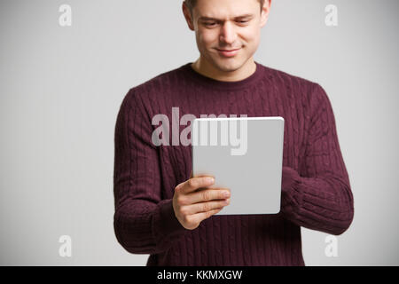 Smiling young white man holding a tablet computer Stock Photo
