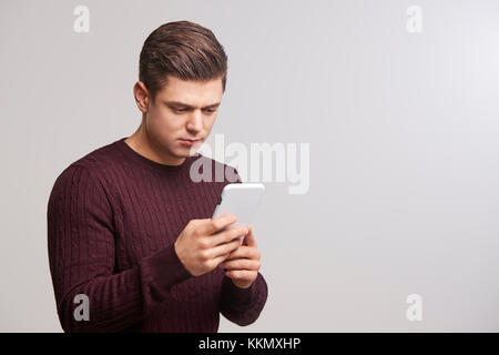 Portrait of a young white man using a smartphone Stock Photo