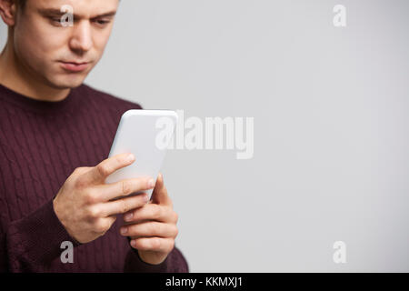 Cropped portrait of a young white man using a smartphone Stock Photo