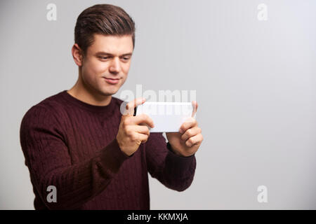 Young white man taking a selfie with his smartphone Stock Photo