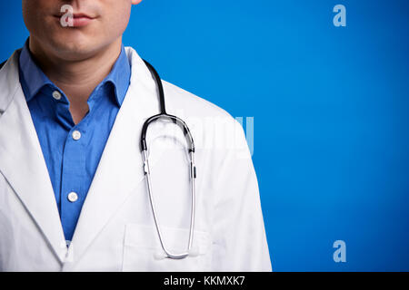 Young white male doctor with stethoscope, cropped portrait Stock Photo