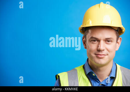 Smiling young white construction worker in hard hat Stock Photo