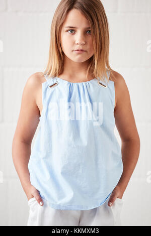 Portrait Of Stylish Young Girl Posing In Studio Against White Stock Photo