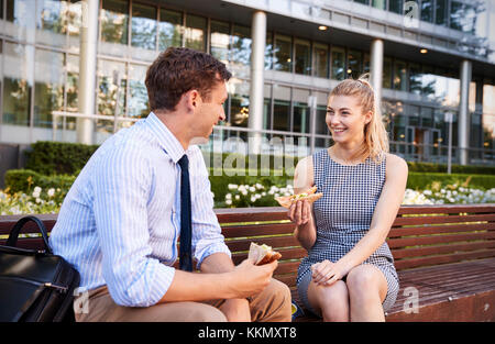 Businessman And Businesswoman Eating Lunch Outside Office Stock Photo
