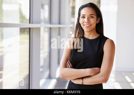 Portrait of young woman looking to camera with arms crossed Stock Photo