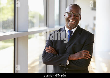 Portrait of a smiling businessman with arms crossed Stock Photo