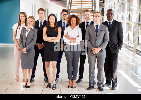 Office workers in a modern lobby, full length group portrait Stock Photo