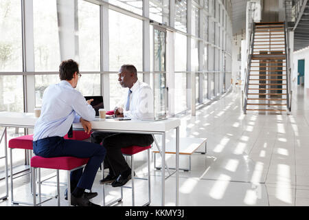 Two businessman talking during a meeting Stock Photo