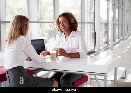 Two young businesswomen at a meeting  talking, close up Stock Photo