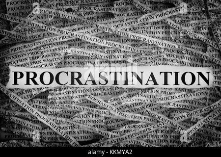 Procrastination. Torn pieces of paper with word Procrastination. Concept Image. Black and White. Closeup. Stock Photo