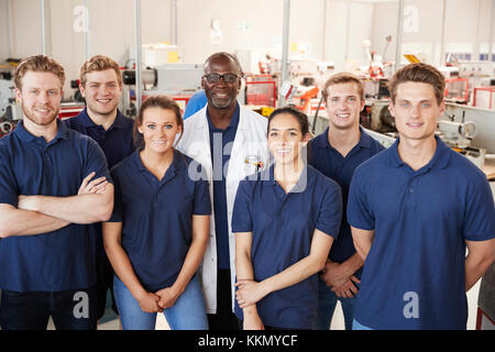 Engineer with apprentices in factory, group portrait Stock Photo