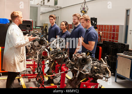 Apprentices studying car engines with a mechanic Stock Photo