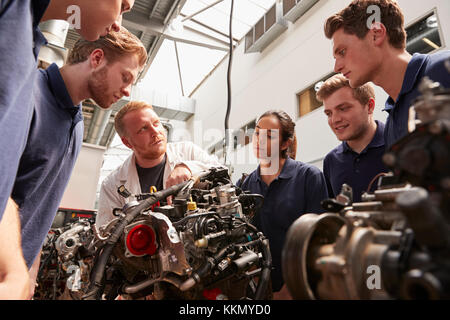 Mechanic showing engines to apprentices, low angle Stock Photo