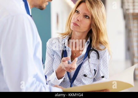 Young male and female doctors in consultation Stock Photo