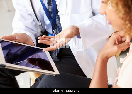 Two senior doctors using tablet computer, mid section Stock Photo