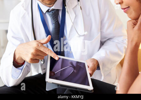 Two senior doctors using tablet computer, mid section Stock Photo