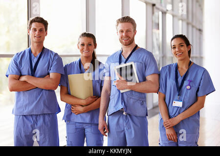 Group portrait of healthcare workers in hospital corridor Stock Photo