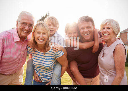 Multi generation family in garden smile to camera, close up Stock Photo